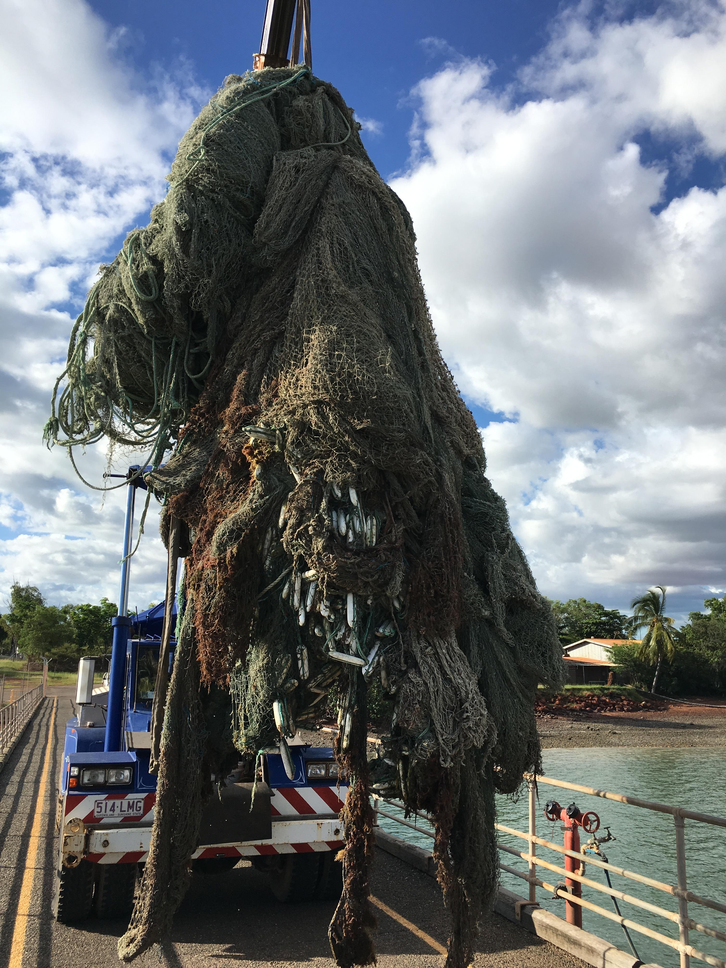 ghost net being lifted onto land
