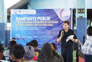 Fisheries officer talking to a group of people.