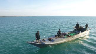 An illegal fishing boat after being boarded by uniformed officers.