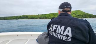 AFMA fisheries officer looking out at an island in the Torres Strait