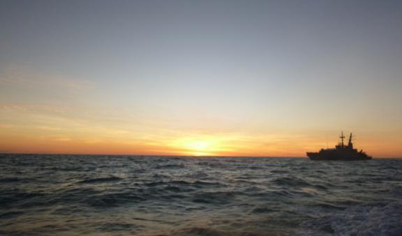 Large boat at sea in sunset